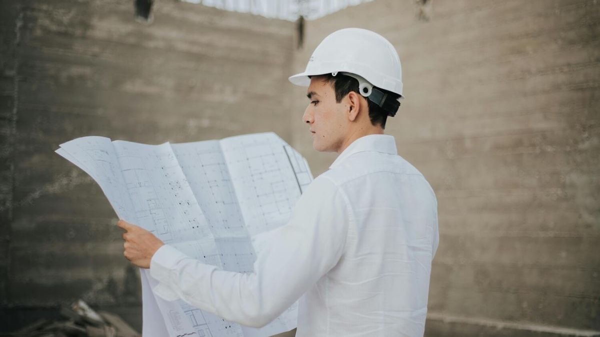 Contractor in Portsmouth, NH reading the blueprints for a renovation project