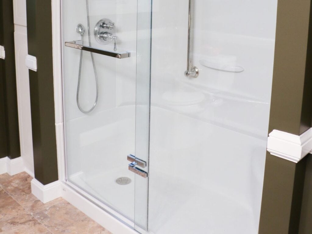 Aker by Maax acrylic shower replacement with modern shower doors and Delta shower valve and hand shower in a Dover, NH bathroom renovation