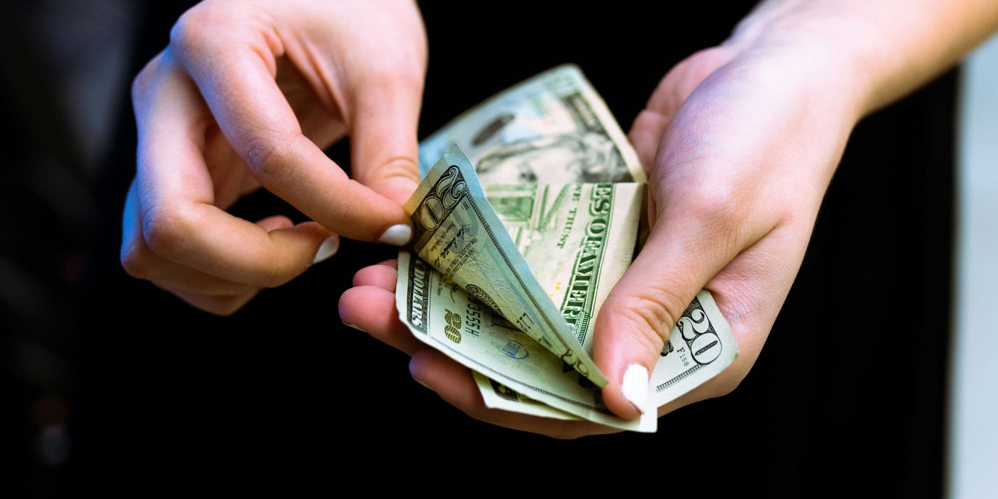 Woman counting money as payment for a bathroom remodel in Portsmouth, NH