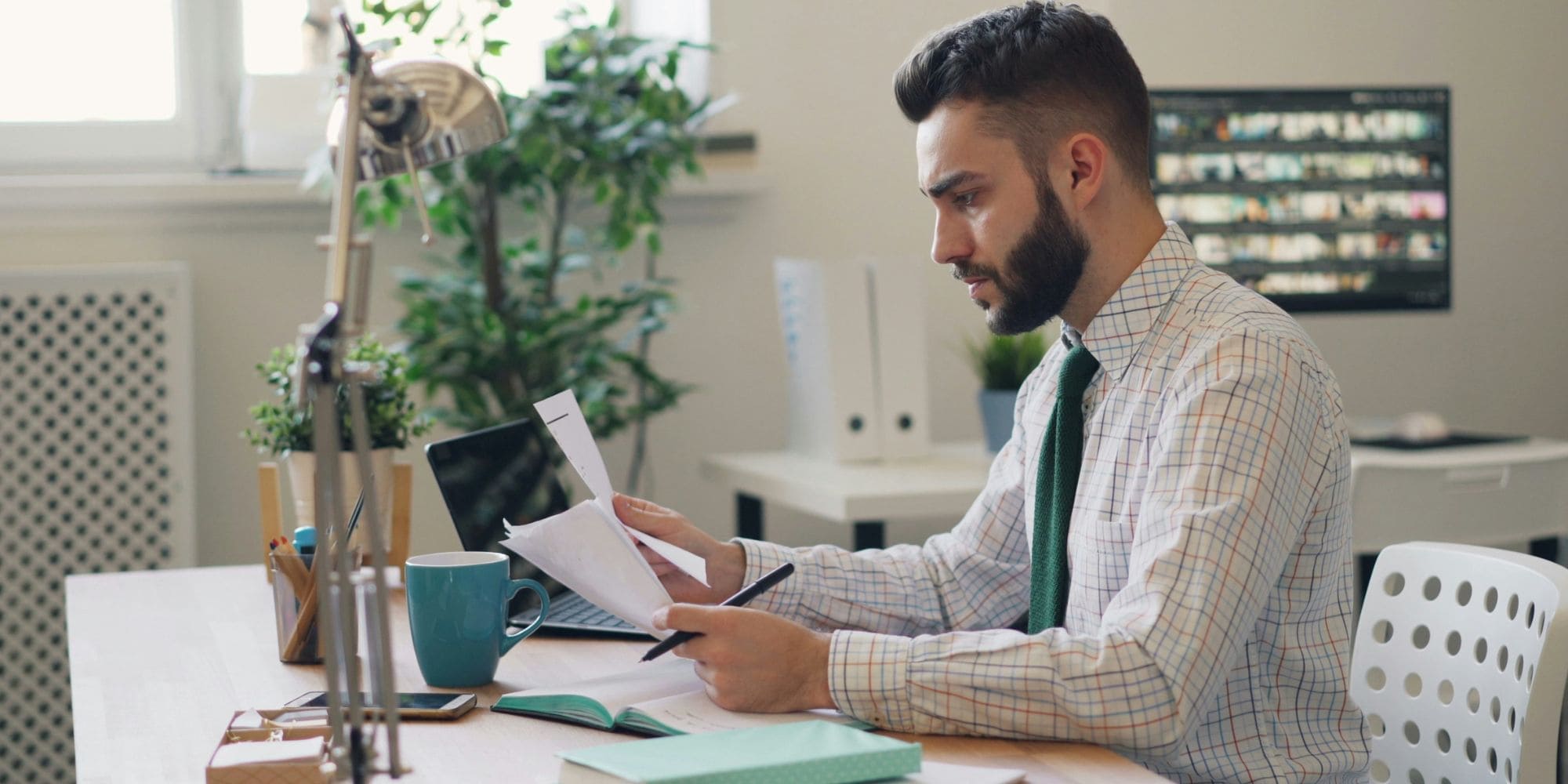 Young professional man comparing remodel contractor quotes in Portsmouth, NH