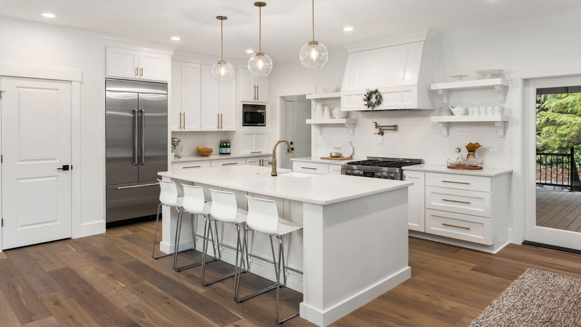 Custom kitchen remodel in North Hampton, NH with a custom island, quartz countertops, tile backsplash, and hardwood floors