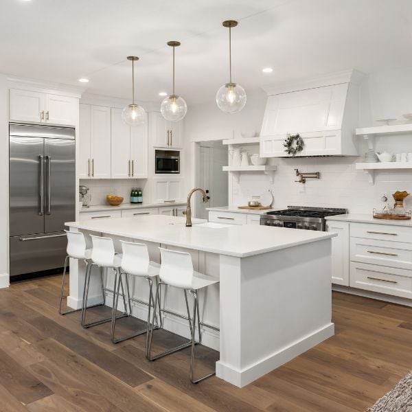 Kitchen remodel in Exeter, NH with custom cabinetry, quartz countertops, and custom vent hood