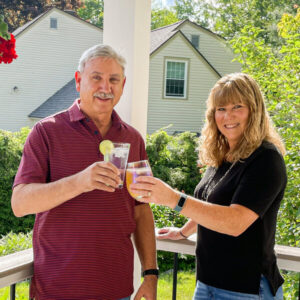 Happy homeowners toasting with a cocktail in their newly remodeled home