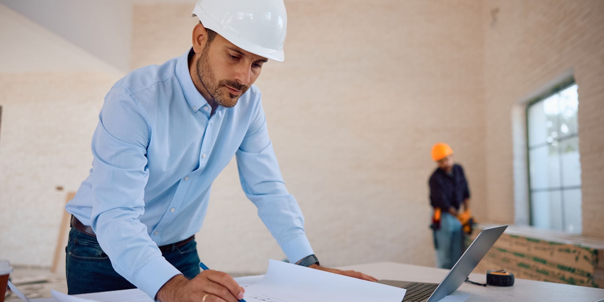 General contractor reading blueprints for a whole home remodel in Portsmouth, nH