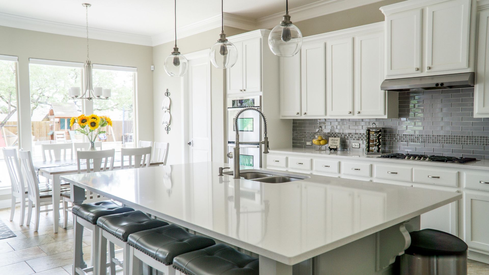 Kitchen remodel with a large island, quartz countertops, and tile backsplash in Portsmouth, NH