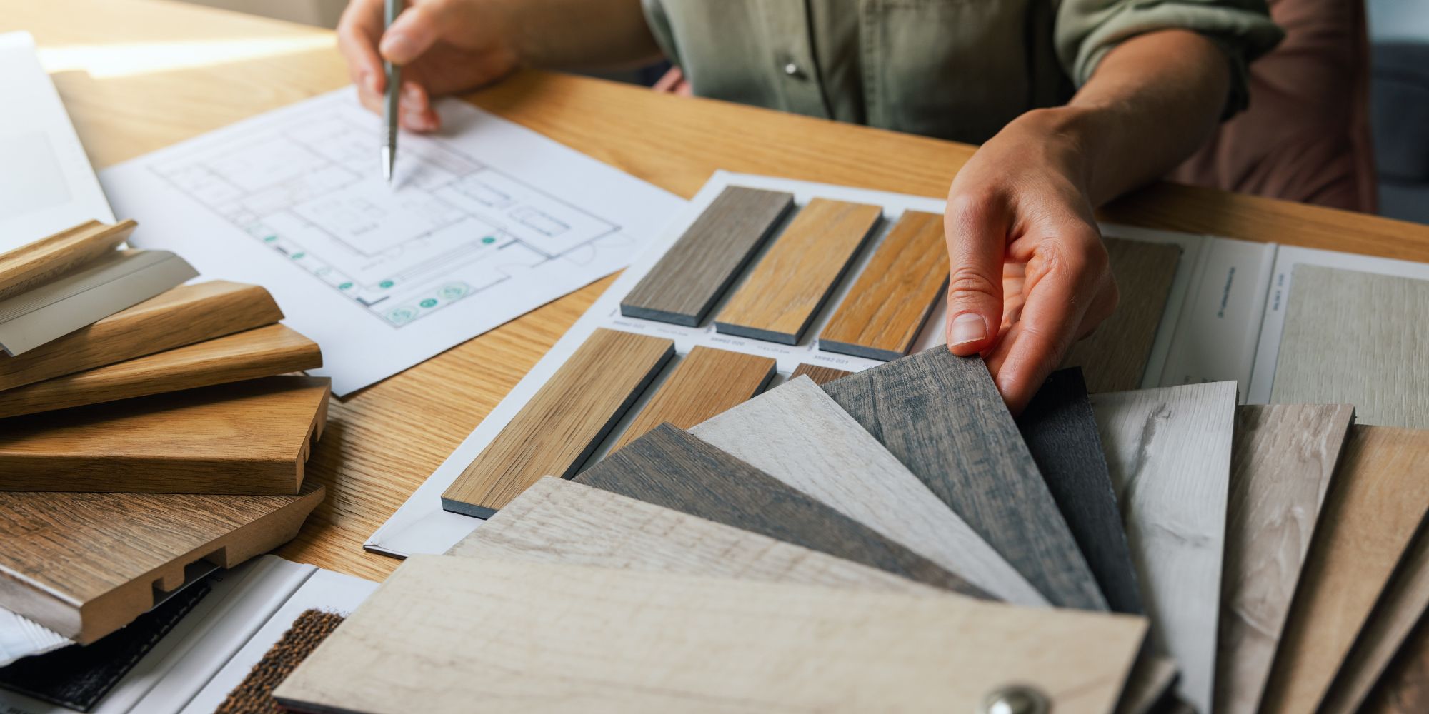 Designer holding color samples as he chooses stain colors for a home remodel in the NH seacoast
